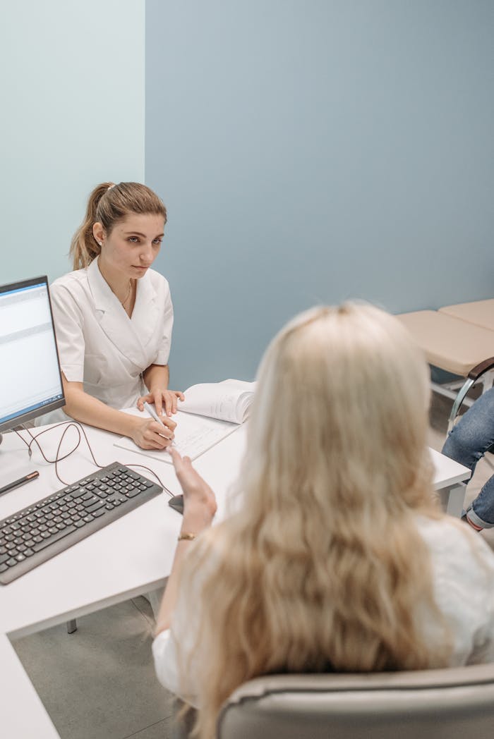 A doctor consults with a patient in a modern office setting, fostering communication.